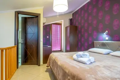 a bedroom with two towels on a large bed at Areti Suites in Kathiana