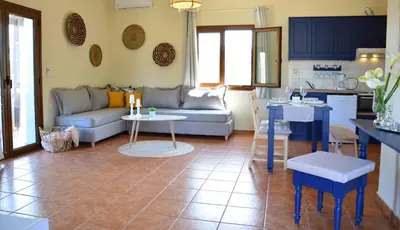 a living room with a couch and a table at Elianthos Villas in Vamos