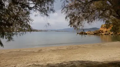 a beach with a view of the water at Dennis Stylish Apartment in Kato Daratso