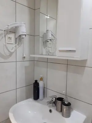 a bathroom with a white sink and a mirror at Dennis Stylish Apartment in Kato Daratso