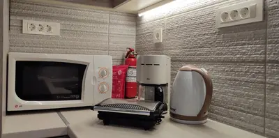 a microwave and a coffee maker on a counter at Dennis Stylish Apartment in Kato Daratso