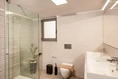 a bathroom with a shower and a toilet and a sink at Kagiemar Luxury House in Perivólia