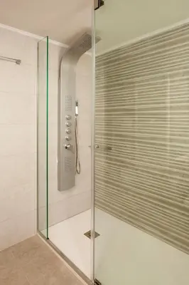 a shower with a glass door in a bathroom at Kagiemar Luxury House in Perivólia