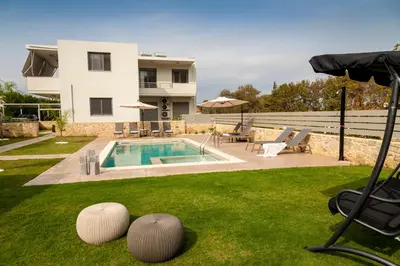 a villa with a swimming pool and a house at Kagiemar Luxury House in Perivólia