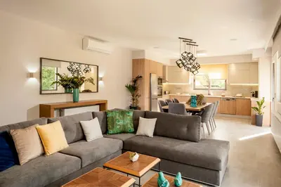 a living room with a couch and a kitchen at Kagiemar Luxury House in Perivólia