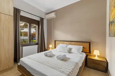 a bedroom with a bed with two towels on it at Casa Veranda - 3 Bedroom House with BBQ & Backyard in Chania Town