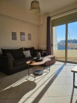 a living room with a couch and a table at Pilot Lux Apartment in Chania Town