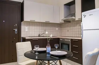 a kitchen with a table with two wine glasses on it at Pilot Lux Apartment in Chania Town