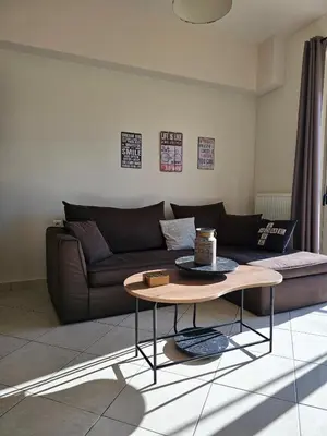 a living room with a couch and a coffee table at Pilot Lux Apartment in Chania Town