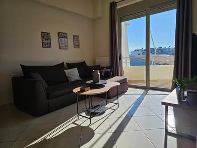 a living room with a couch and a table at Pilot Lux Apartment in Chania Town