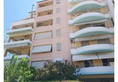 a tall pink building with lots of windows at Pilot Lux Apartment in Chania Town