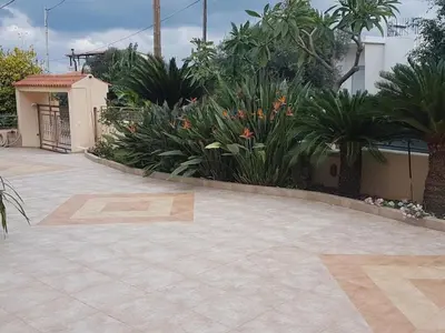 a patio with a bunch of plants and flowers at Rias Sea View Apartment in Kato Daratso