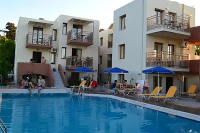 a swimming pool in front of a hotel at Alexandros M in Maleme