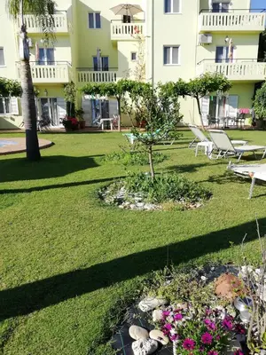 a garden in front of a building at Kalithea Apartments - Heated Pool in Kalyves