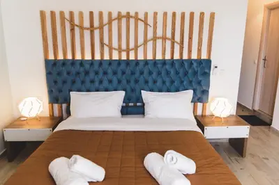 a bedroom with a large bed with towels on it at Dome Rooms Downtown in Chania Town