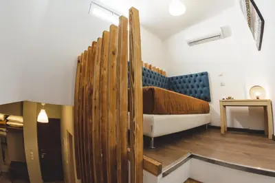 a room with a bed with a wooden wall at Dome Rooms Downtown in Chania Town