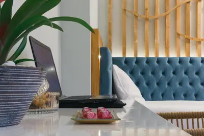 a table with a laptop computer and a plate of food at Dome Rooms Downtown in Chania Town