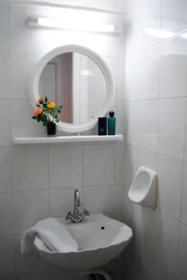 a white bathroom with a sink and a mirror at Marita's Apartments in Agia Marina Nea Kydonias