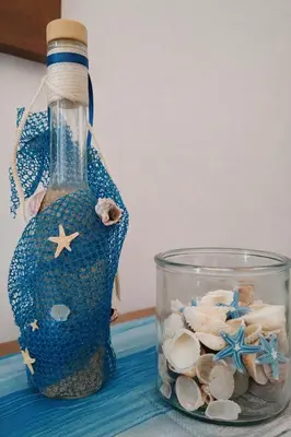 a bottle filled with shells and a glass container at Konstantina's cottage Ideal BaseforBalos & Elafonisi in Kissamos