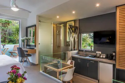 a kitchen and living room with a glass counter top at Forum Suites in Kato Daratso