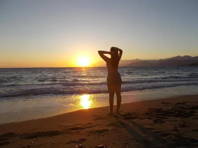 a woman standing on the beach watching the sunset at Dimitra's Sea-Crafts Boutique Studios in Kalyves