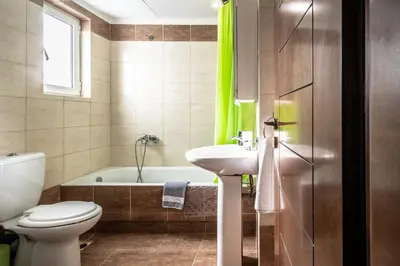 a bathroom with a toilet and a sink and a tub at Chania Central Flat in Chania Town