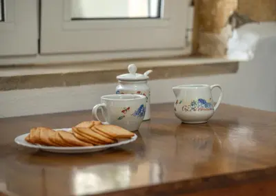 a table with two cups and a plate of croissants at Grandma's Nest in Kissamos