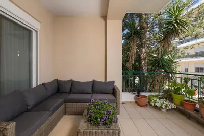 a living room with a couch on a balcony at Natalia Guest House in Chania Town