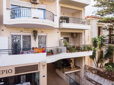 an apartment building with balconies and plants at Natalia Guest House in Chania Town