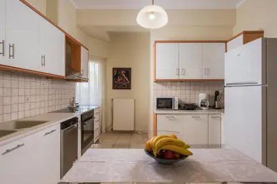 a kitchen with a bowl of bananas on a counter at Natalia Guest House in Chania Town
