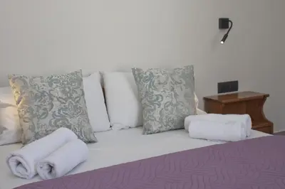 a bedroom with a bed with towels on it at Vaso Apartments in Plataniás