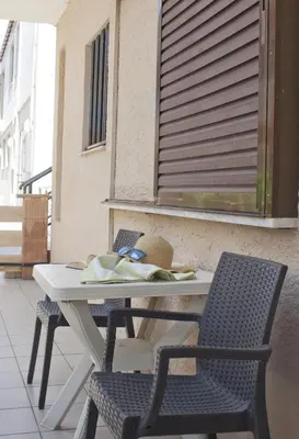 a white table and chairs on a patio at Vaso Apartments in Plataniás
