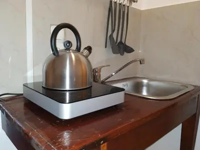a tea kettle sitting on a counter next to a sink at Casa Patrikò Chania in Perivólia