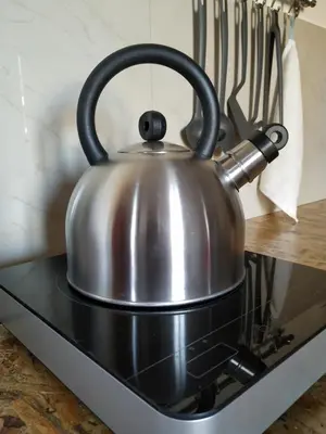 a metal tea kettle on top of a stove at Casa Patrikò Chania in Perivólia