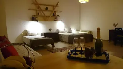 a living room with a table and two wine glasses at Casa Patrikò Chania in Perivólia