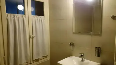 a bathroom with a sink and a shower with a mirror at Casa Patrikò Chania in Perivólia