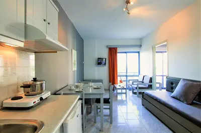 a kitchen and living room with a couch and a table at Balito in Kato Galatas