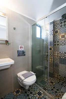 a bathroom with a toilet and a glass shower at Balito in Kato Galatas