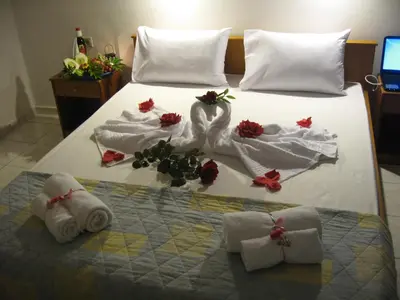 a bed with towels and flowers on it at Despina Studios in Agia Marina Nea Kydonias