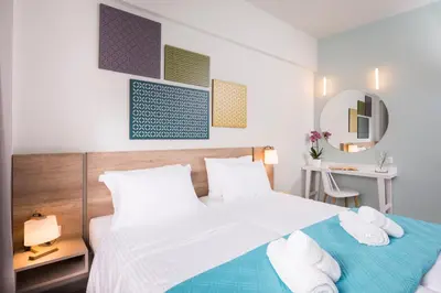 a bedroom with a large bed with towels on it at IRINI STALOS Apartments in Stalos