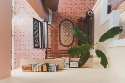 a room with a shelf with books and a mirror at Dionyssos Village in Kato Daratso