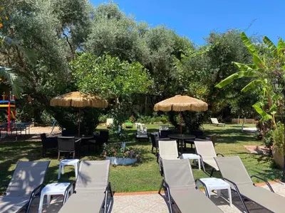 a group of chairs and tables with umbrellas at Dionyssos Village in Kato Daratso