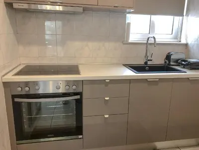 a kitchen with a sink and a stove at Sofia City Beach 3 Apts Nea Chora Chania steps from the beach in Chania Town
