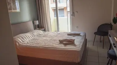 a bedroom with a bed with two towels on it at Sofia City Beach 3 Apts Nea Chora Chania steps from the beach in Chania Town