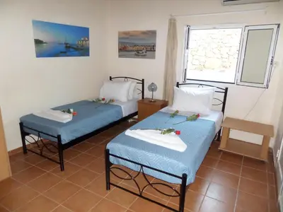 a room with two beds and a window at Endless Blue in Ravdhoúkha