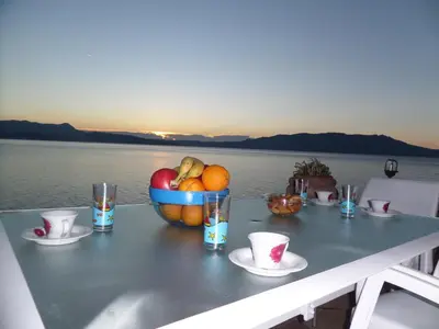 a table with a bowl of fruit on top of the water at Endless Blue in Ravdhoúkha