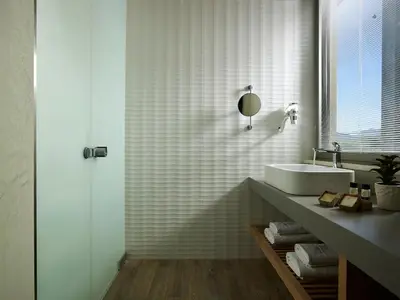 a white bathroom with a sink and a mirror at Youphoria Beach Front Villas in Korfalónas
