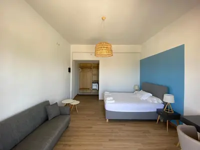 a living room with a bed and a couch at Blue Sky in Frangokastello