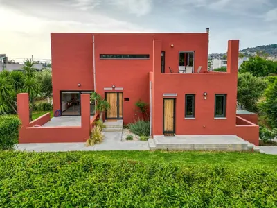 a red house with a green yard at Red Castle in Souda