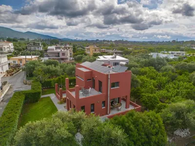 an aerial view of a red house in a city at Red Castle in Souda